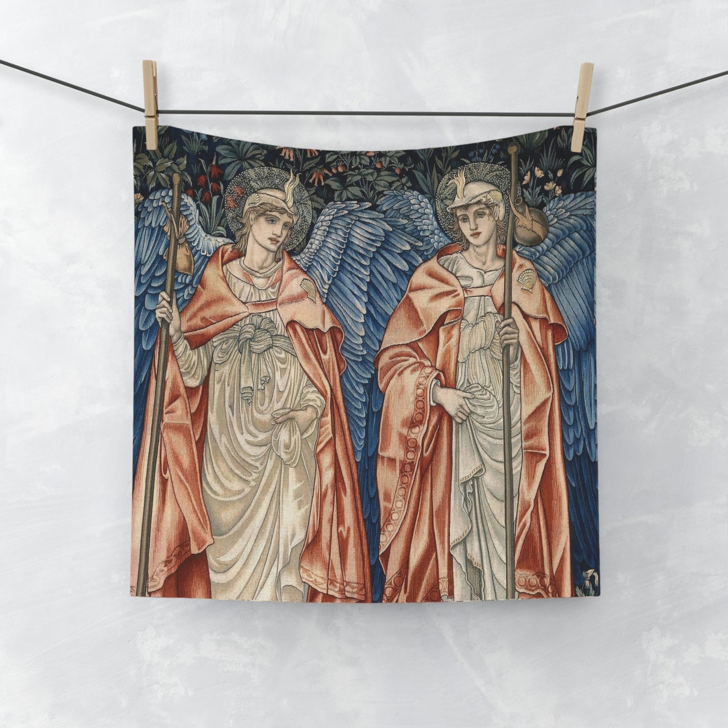 A white washcloth with a printed floral pattern inspired by William Morris, featuring two angels in a vintage style.