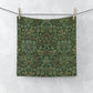 A green washcloth with a floral pattern inspired by William Morris.