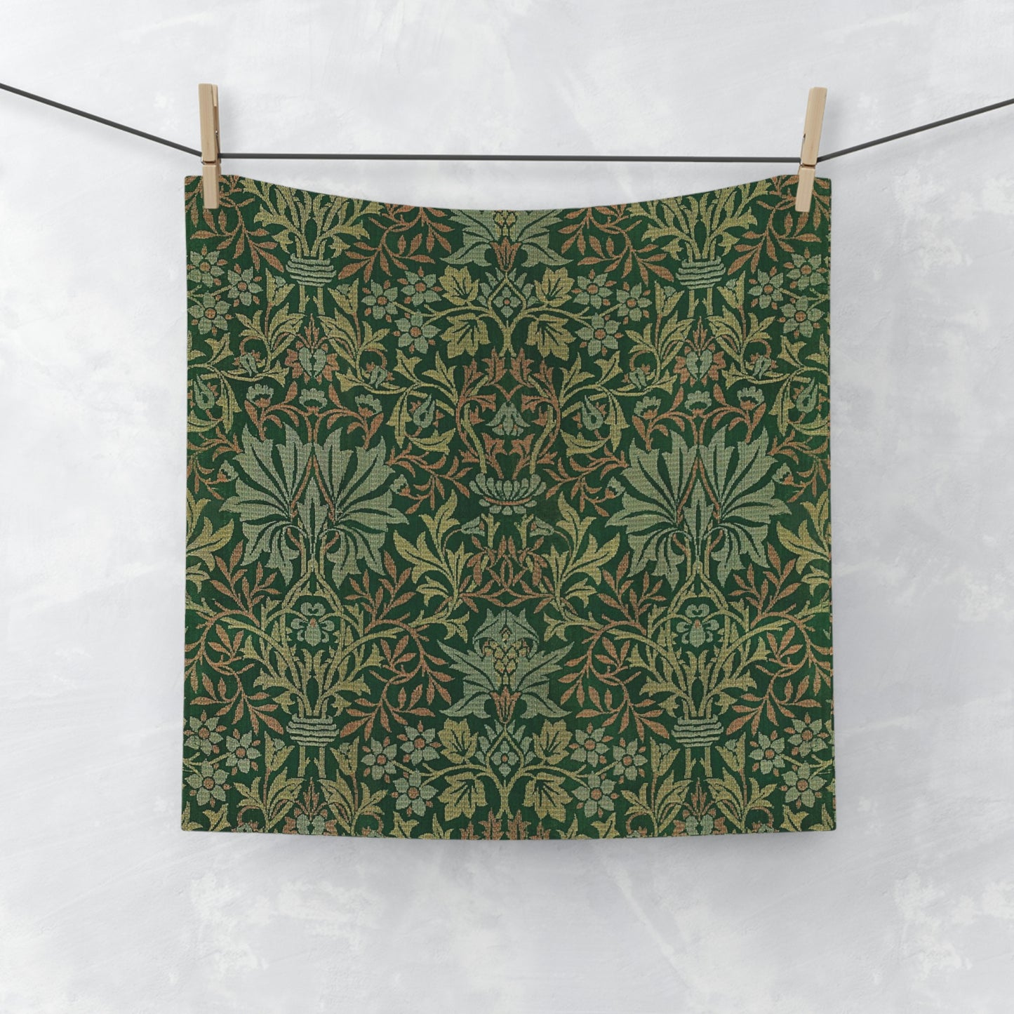 A green washcloth with a floral pattern inspired by William Morris.