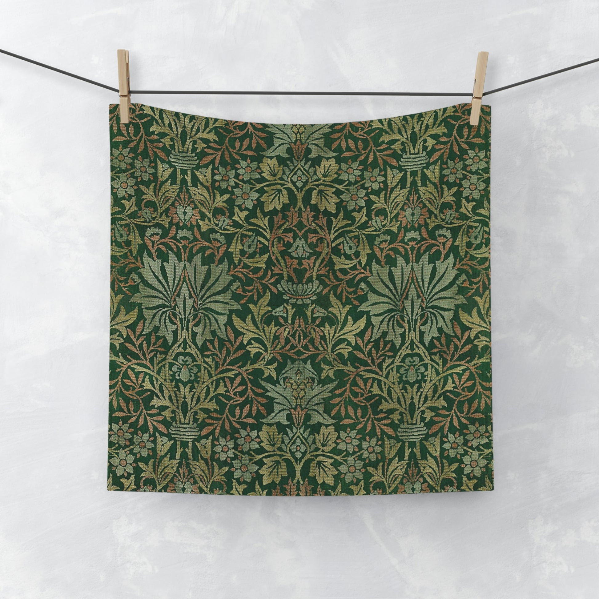 A green washcloth with a floral pattern inspired by William Morris.