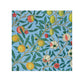 A face cloth with a floral pattern inspired by William Morris, featuring a mix of green and red fruits on a blue background.