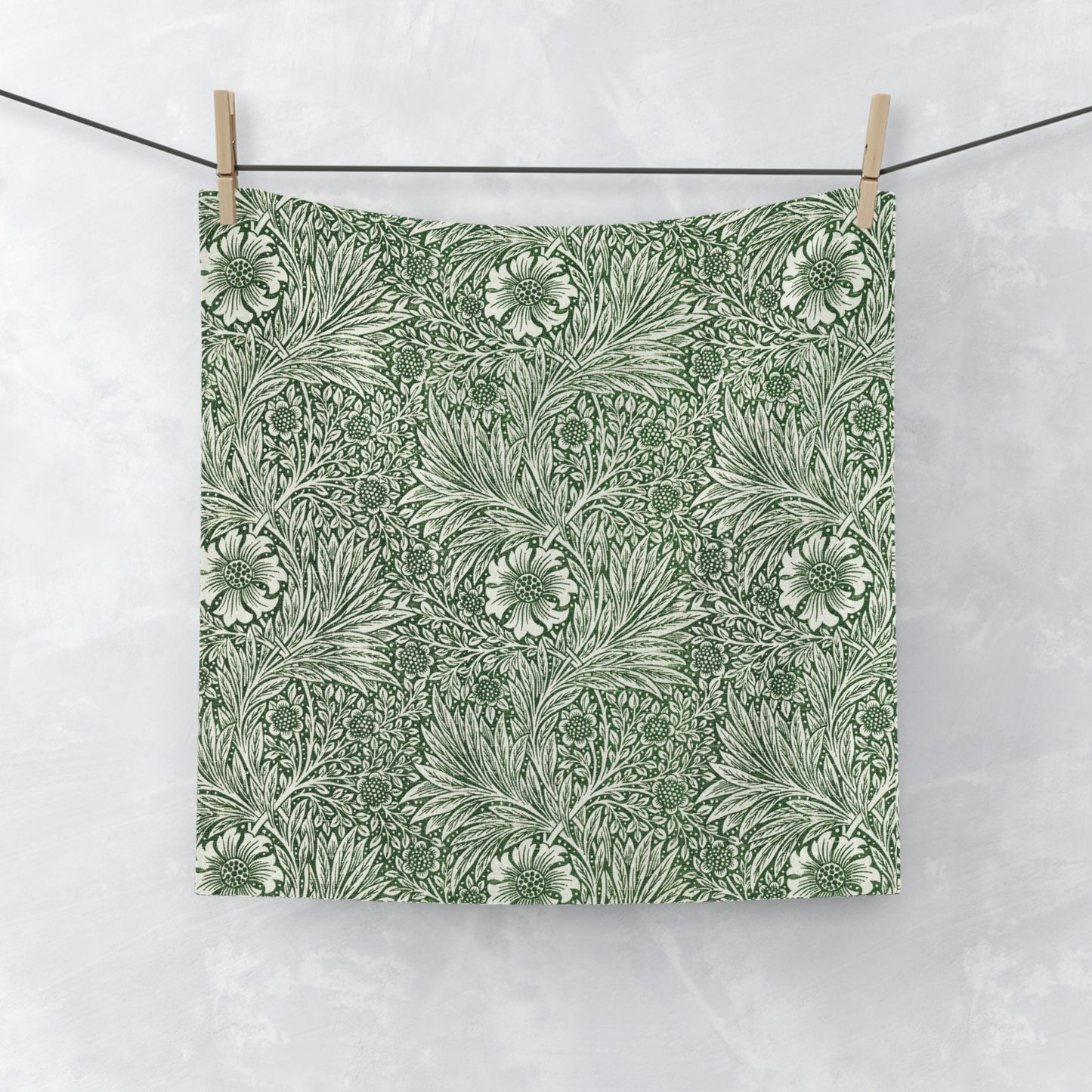 A white washcloth with a green floral pattern inspired by William Morris's art.
