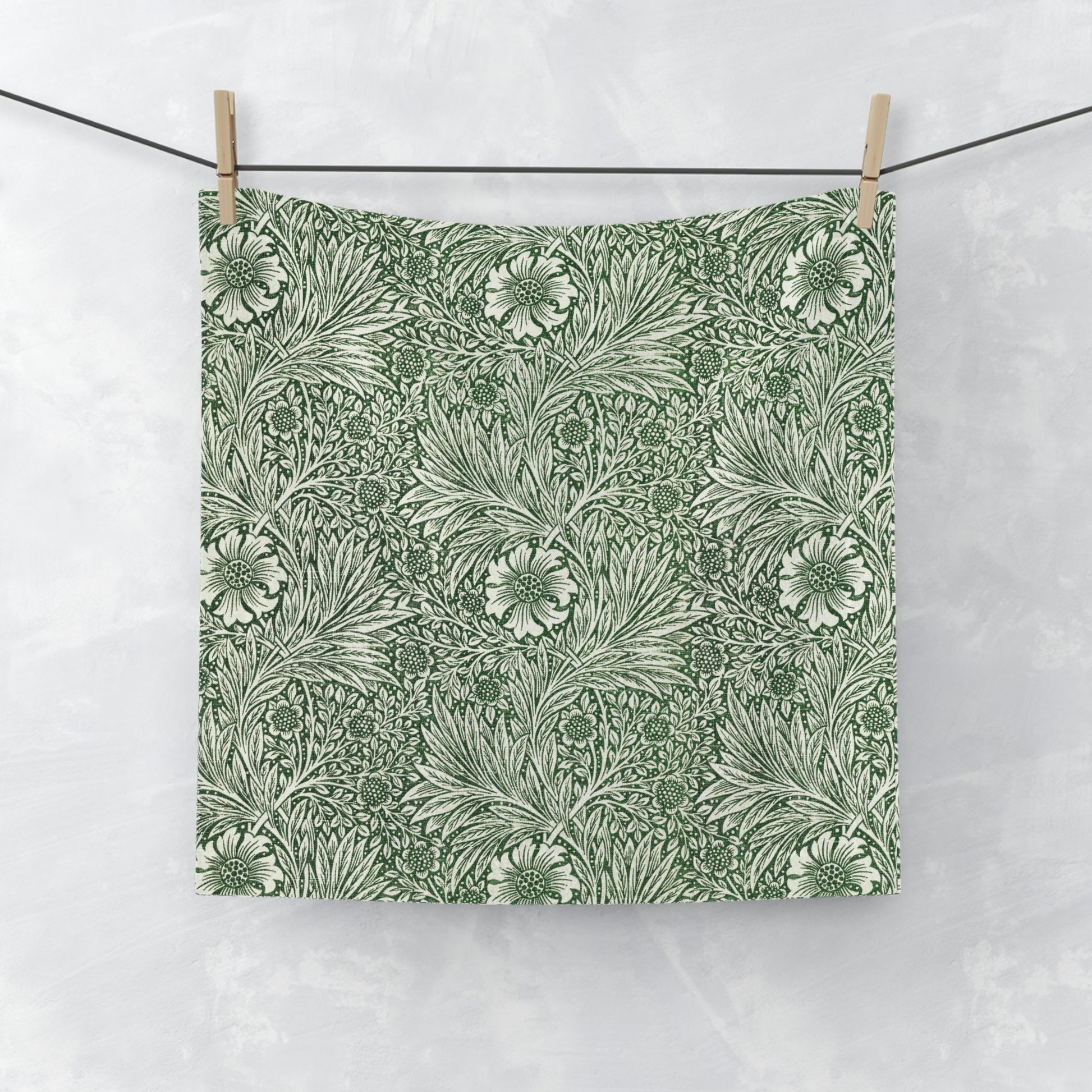 A white washcloth with a green floral pattern inspired by William Morris's art.