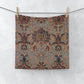 A white washcloth with a floral pattern inspired by William Morris, featuring a mix of colourful floral designs.
