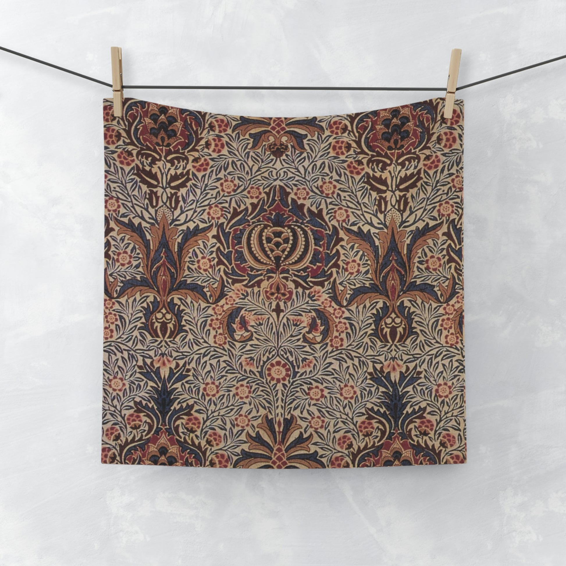 A white washcloth with a floral pattern inspired by William Morris, featuring a mix of colourful floral designs.