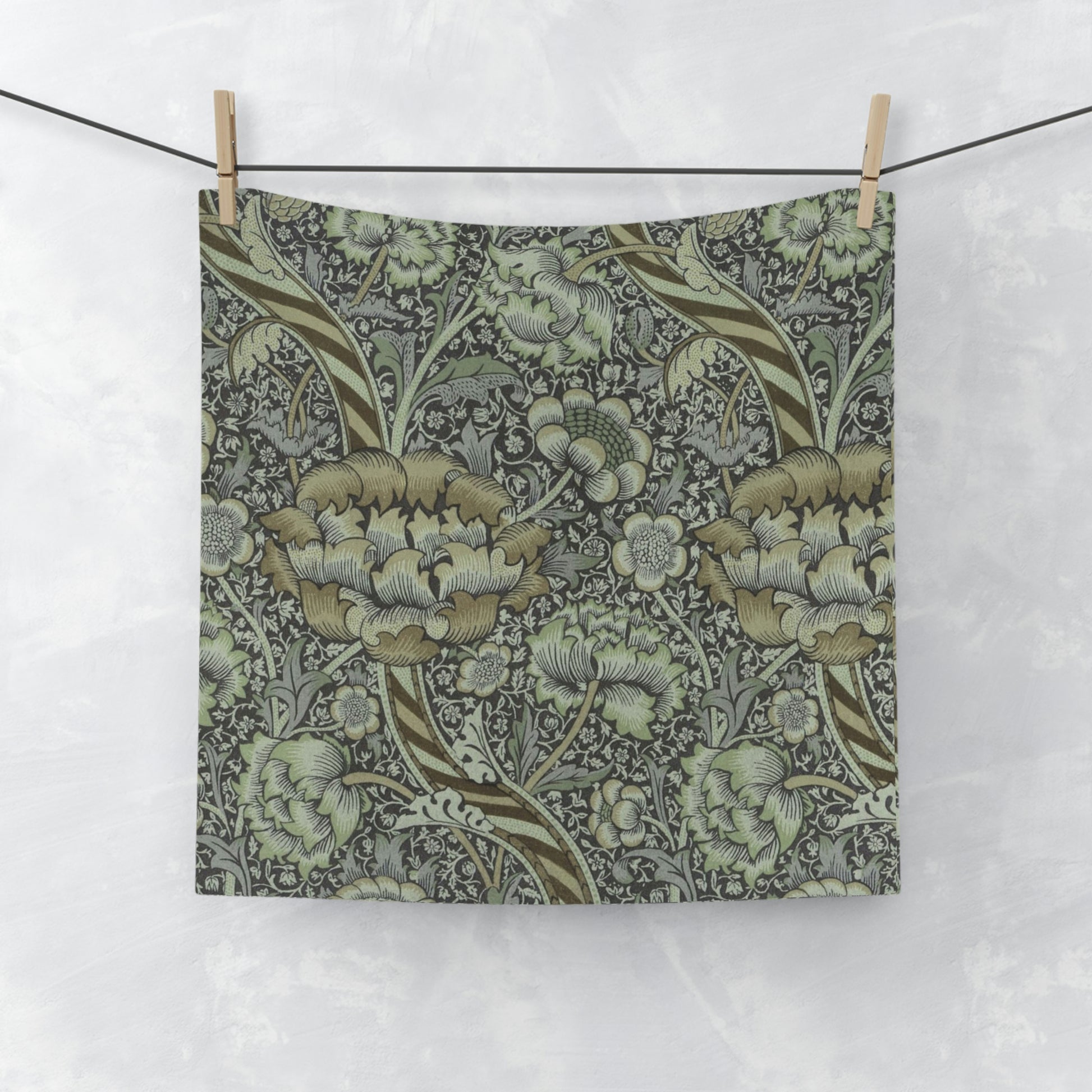 A gray and multicolored floral patterned washcloth inspired by William Morris' Wandle Collection.
