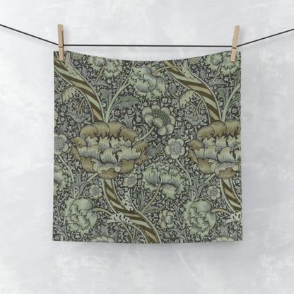 A gray and multicolored floral patterned washcloth inspired by William Morris' Wandle Collection.