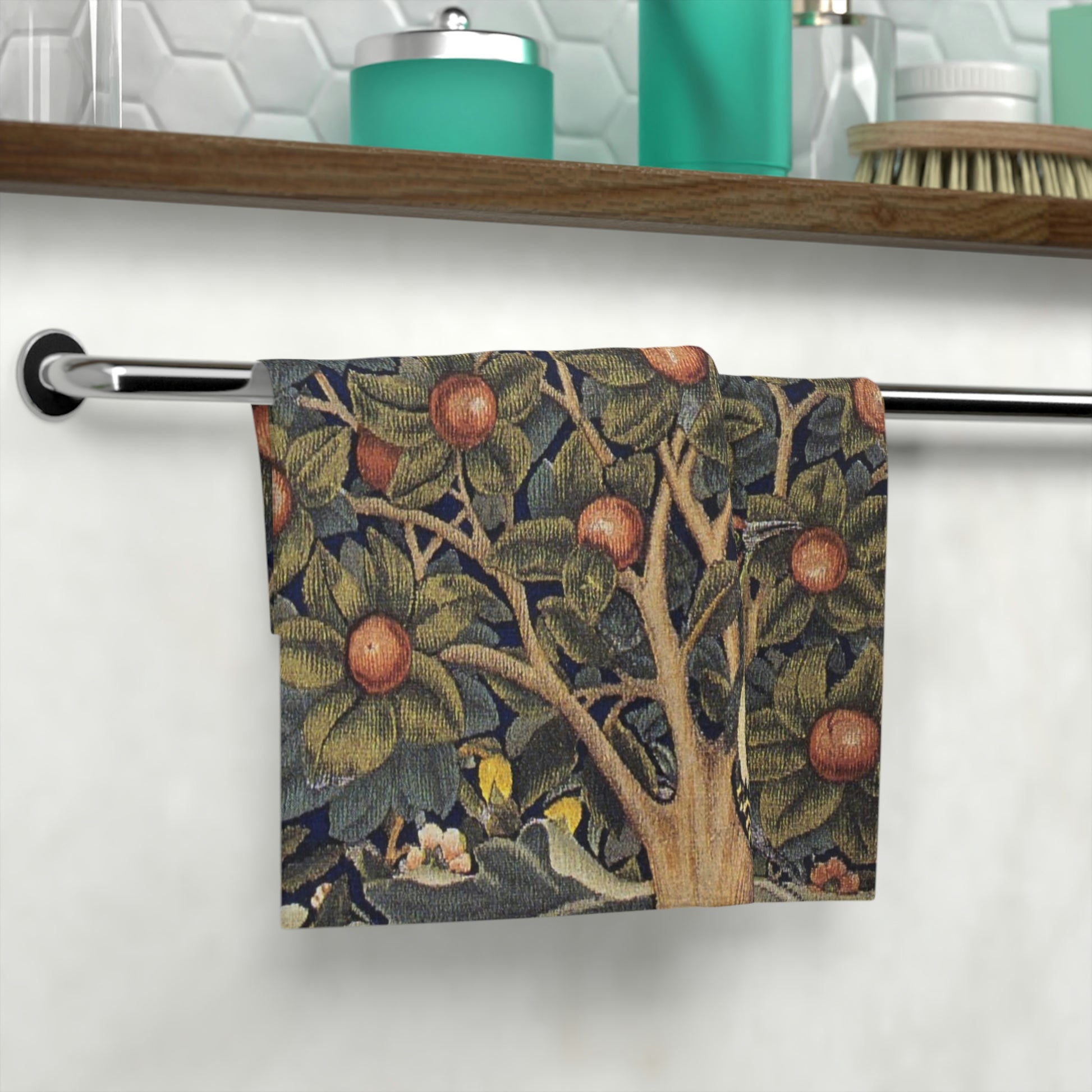A washcloth with a floral pattern inspired by William Morris, featuring birds and woodpeckers amidst green leaves and red fruits.