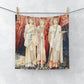A washcloth featuring an artistic print with red angels inspired by William Morris from the Holy Grail Collection.