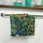 A washcloth with a floral pattern featuring a pheasant design, inspired by William Morris' art.