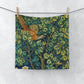 A washcloth with a floral pattern featuring a pheasant design, inspired by William Morris' art.