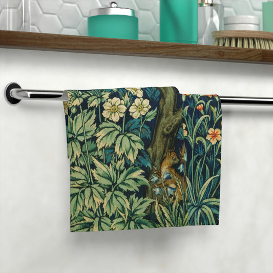 A white washcloth with a floral pattern inspired by William Morris, featuring an illustration of squirrels and leaves.